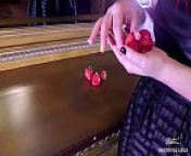 Juicy strawberry squeezed closeup by cute bare feet on the dresser from erika eden squeezing fresh juices