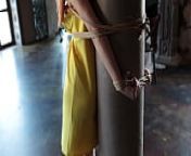 Girl tied to a column from chinese rope bondage