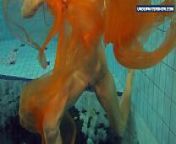 Yellow and Red clothed teen underwater from teen ocean