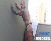 The legend of muscles and ink: Tattooed giant Rob Diesel, shows his power on the balcony from kenyan man shows his penis